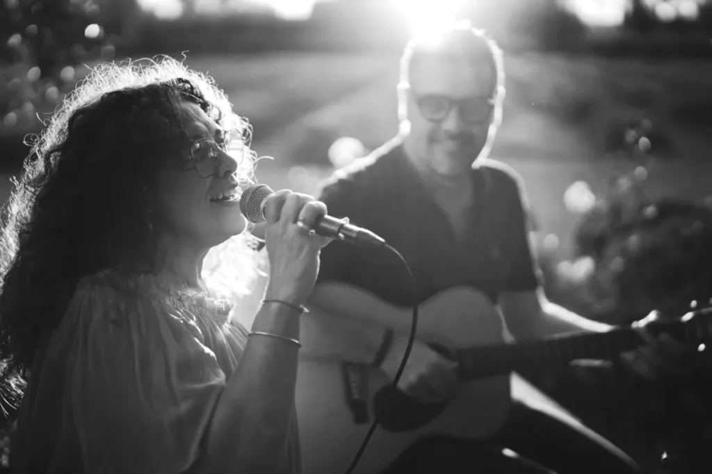 Female Singer and guitarist perform during a destination wedding in the south of France